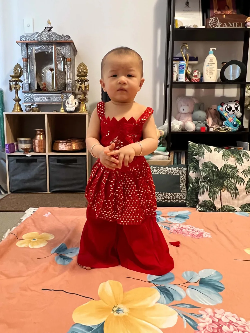 Aira dressed in a bright red traditional outfit